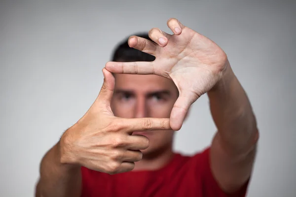 Man makes frame with his fingers