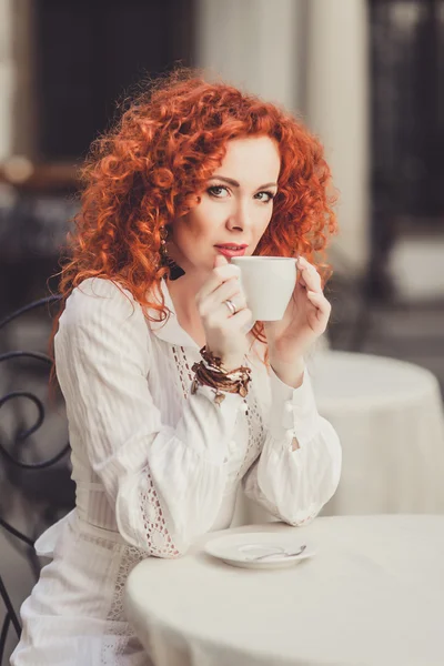 Girl with red hair in  cafe