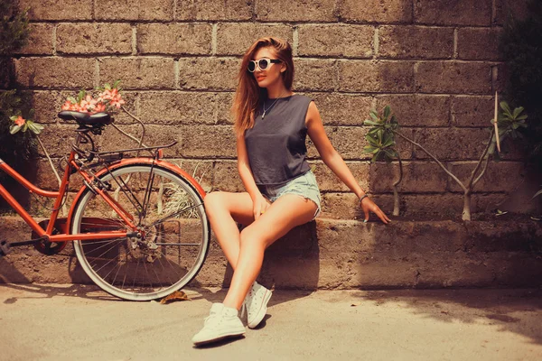 Girl  posing with red bicycle