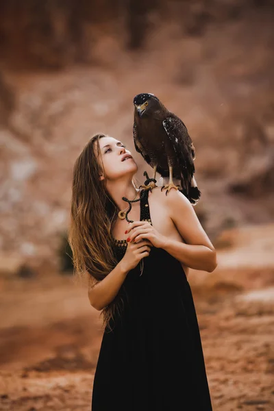 Woman holding eagle on her hand