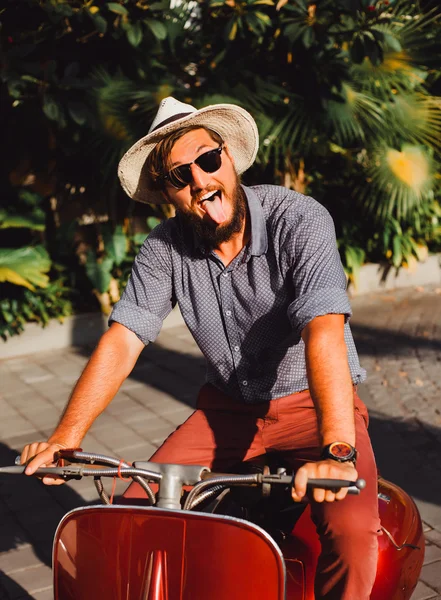 Young guy  posing on  scooter