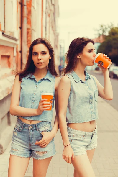 Brunette girlfriends drinking coffee