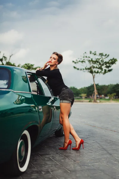 Girl   posing near vintage car