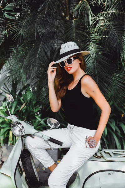 Young girl on  vintage scooter