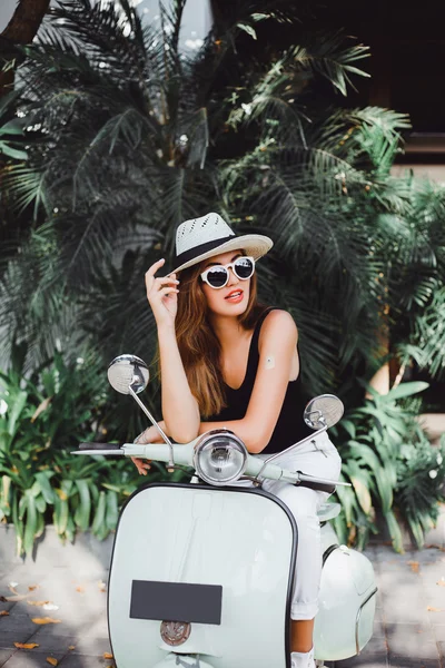 Young girl on  vintage scooter