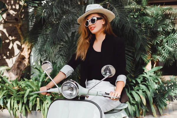 Young girl on  vintage scooter