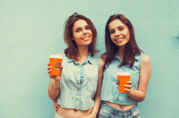 Sisters twins drinking coffee