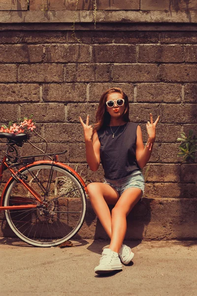 Girl  posing with red bicycle