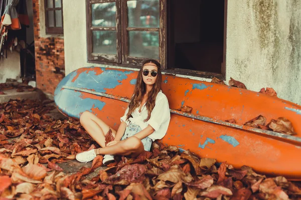 Girl posing  near surfboard