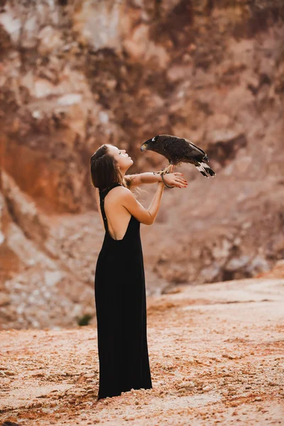 Woman holding eagle on her hand