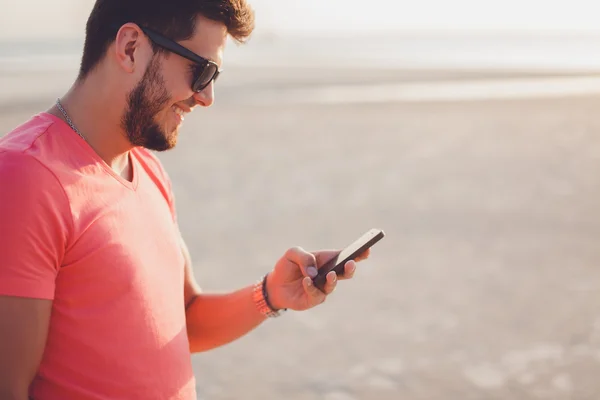 Guy on the beach and  phone