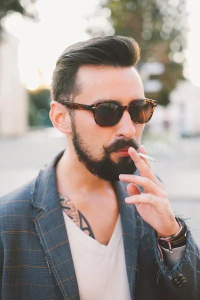 Guy with a beard smoking cigarette