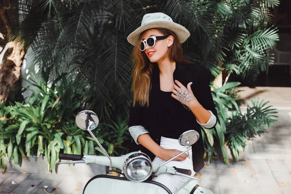 Young girl on  vintage scooter