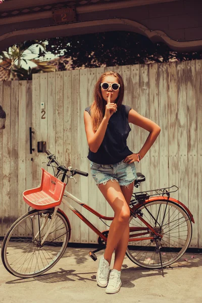 Girl posing with  vintage bicycle