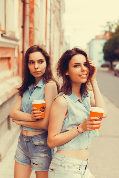 Brunette girlfriends drinking coffee