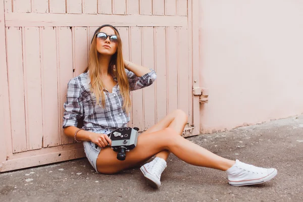 Hipster woman with video camera