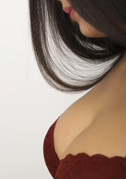 Close-up portrait of a young girls body, tall chest girl in a red bra and a lock of hair