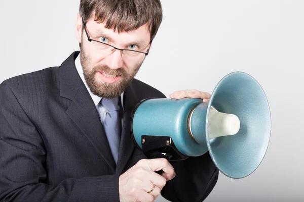 Bearded businessman yelling through bullhorn. Public Relations. man expresses various emotions. photos of young businessman wearing a suit and tie