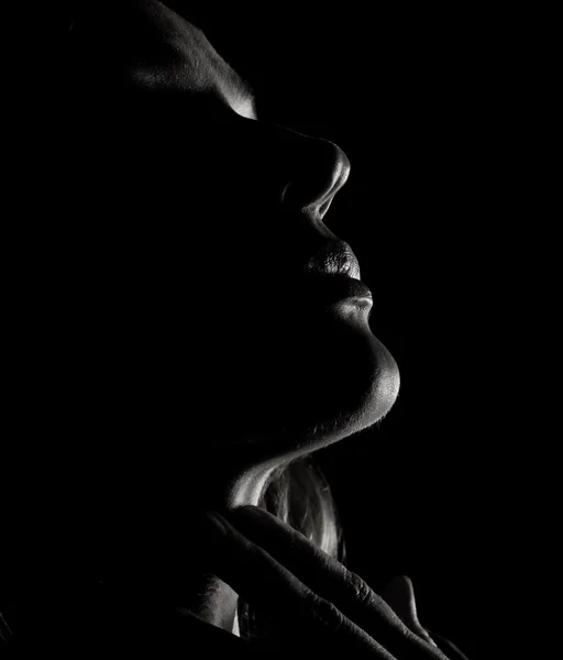 Portrait of beautiful sensuality pensive girl profile with closed eyes in a dark, on a black background