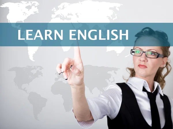 Learn english written on a virtual screen. Internet technologies in business and tourism. woman in business suit and tie, presses a finger on a virtual screen