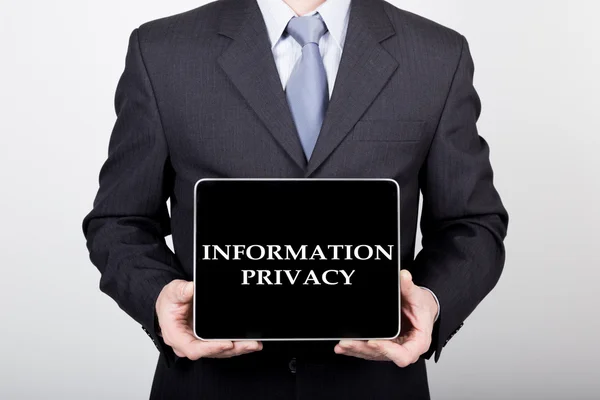 Technology, internet and networking in business concept - businessman holding a tablet pc with information privacy sign. Internet technologies in business