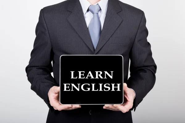 Technology, internet and networking in business concept - businessman holding a tablet pc with learn english sign. Internet technologies in business