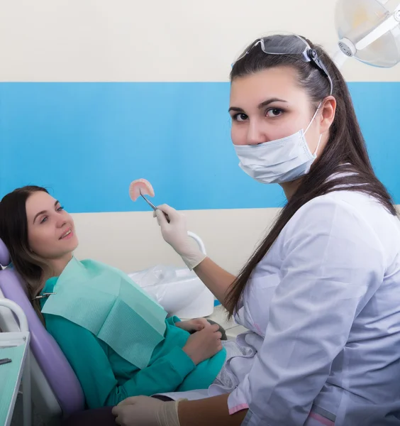 Doctor examines the oral cavity on tooth decay.