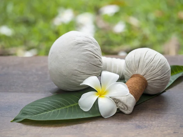 Spa massage compress balls, herbal ball on the leaves with spa flower, Thailand, select focus
