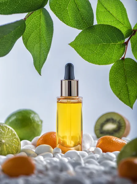 The bottle of fruit cosmetic  moisturizing oil with white stones and fruits