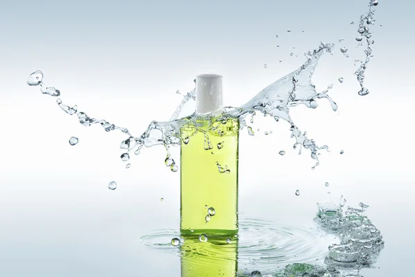 The herbal  moisturizing shampoo stands on the water background with splashes