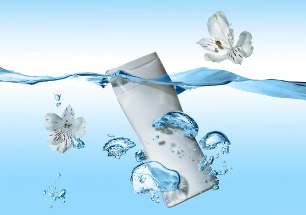 The bottle of cosmetic milk, cosmetic cream, cosmetic water in the blue water wave with splash and  big air bubbles near the bottle
