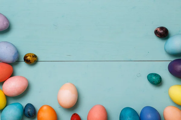 Wooden workplace with colorful eggs