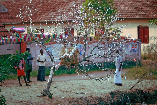 Local residents and the tree decorated for Christmas on the banks of the river the state of Kerala, India