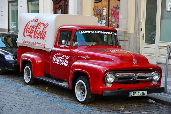 PRAGUE, CZECH REPUBLIC - Oct 23 2015: An old renovated red Ford vintage Coca cola truck (pickup) in a parking lot., Czech Republic, on Oct 23, 2015