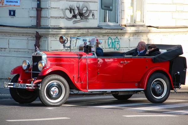 PRAGUE, CZECH REPUBLIC - Oct 24 2015: Red Praga car used for sightseeing tours in the streets of Prague., Czech Republic, on Oct 24, 2015