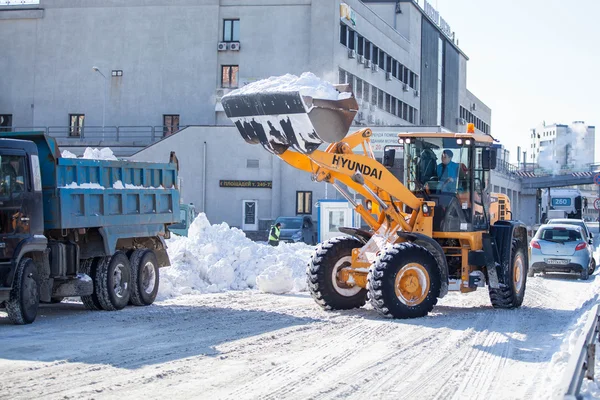 Vladivostok, Russia - January 21, 2016: Front loader claens roads from the snow after heavy snowfall