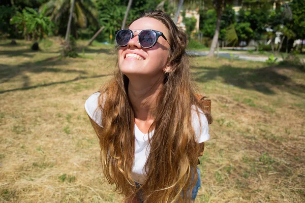 Fashion hipster cool girl in sunglasses and colorful clothes having fun, wearing cute trendy outfit,smiling enjoy her weekends,girl brown hair with an elegant hairstyle,hair wave curly