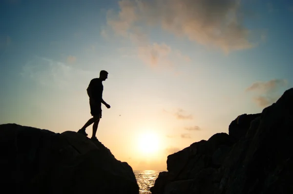 The jumping man on rocks