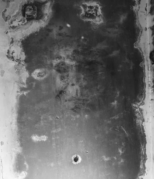 Scary face on a dirty ceiling.