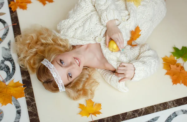 Portrait of a gentle sensual blonde girl lying on the floor with