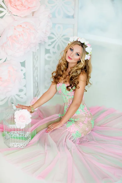 Very beautiful sensual girl with curly blond hair and a wreath o