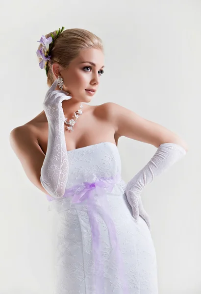 A tender portrait of a beautiful blonde bride in wedding dress w