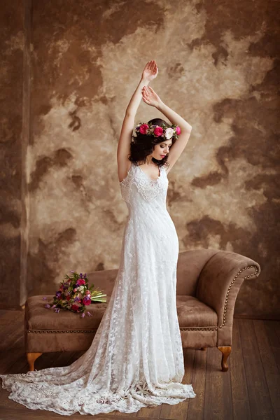 Portrait of beautiful sensual brunette girl in a white lace dres