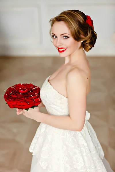 Charming blonde girl with beautiful smile in a white lace dress