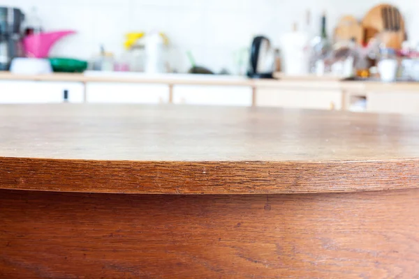 Old rustic table with vintage kitchen defocused background.