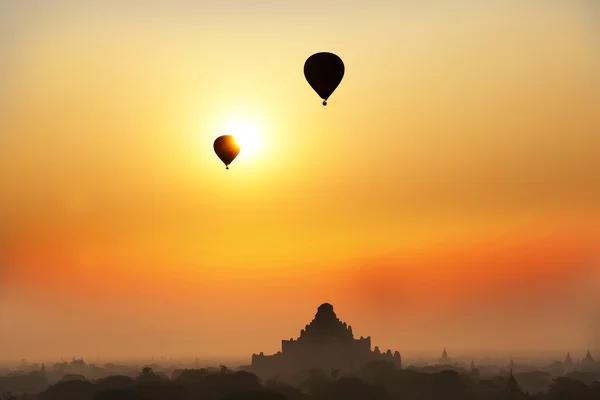 Hot air balloons flying over temples