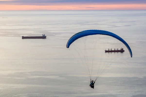 Tourist enjoying paraglide jump