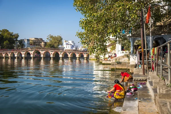 Woman washing clothes in river of Jaipur