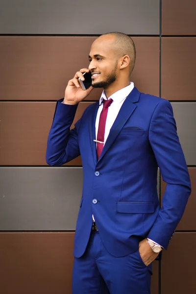 Successful businessman conducts negotiations on phone with important partners. He like his work, talking on the phone.