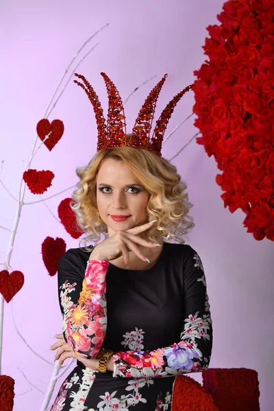 Very beautiful,cheerful, attractive, cute, nice, delightful, adorable, wonderful blonde girl, woman, queen, princess with big, red corona, crown, diadem, coroneta . Holiday St. Valentine\'s Day
